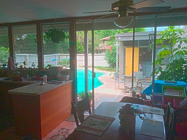The kitchen / dining area looking out to the courtyard. My father's house in Winter Haven has an 8-foot concrete block wall instead of a wooden fence.